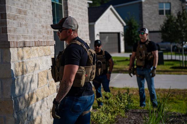 Deputy U.S. Marshals in front of residence during Operation…