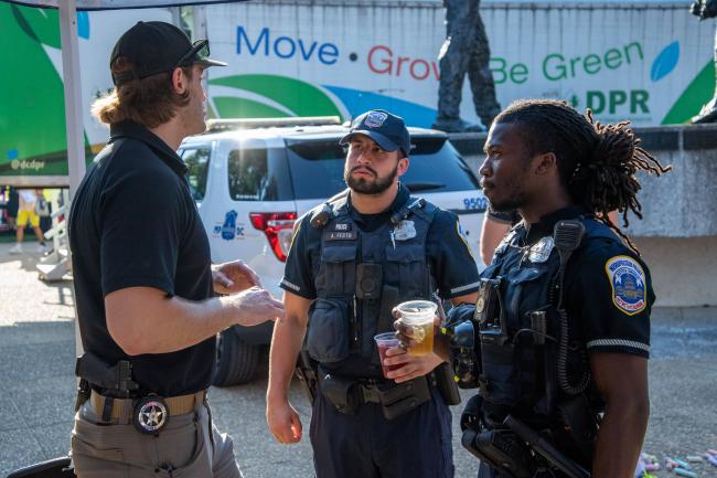 Deputy U.S. Marshals speaking with police officers at the…