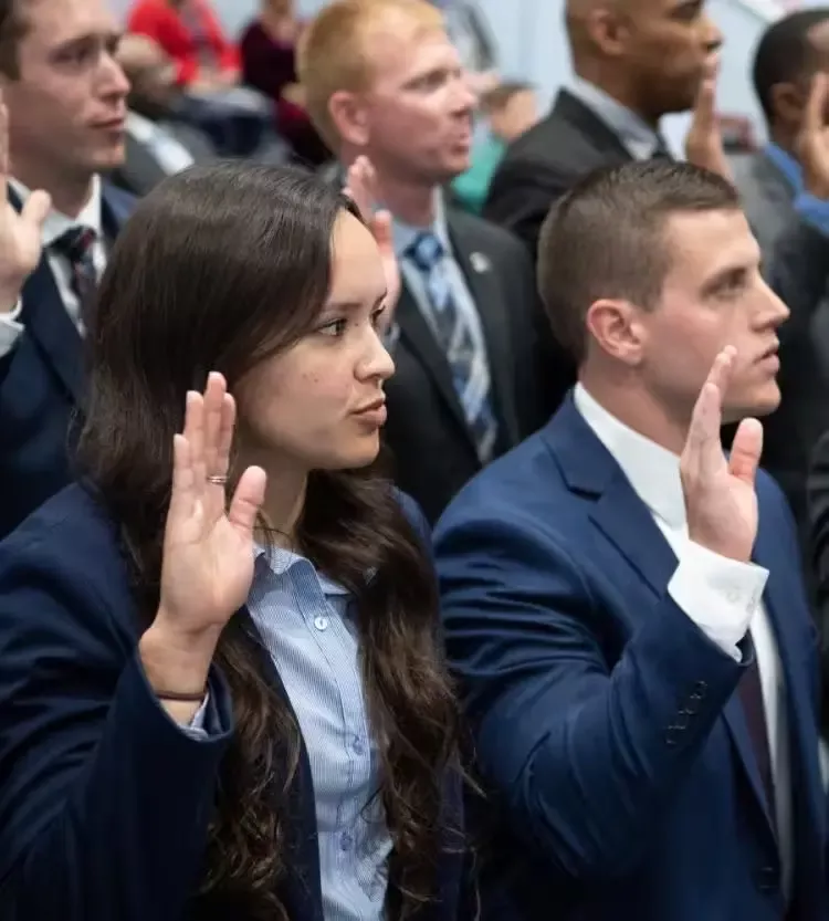 People holding right hands for oath