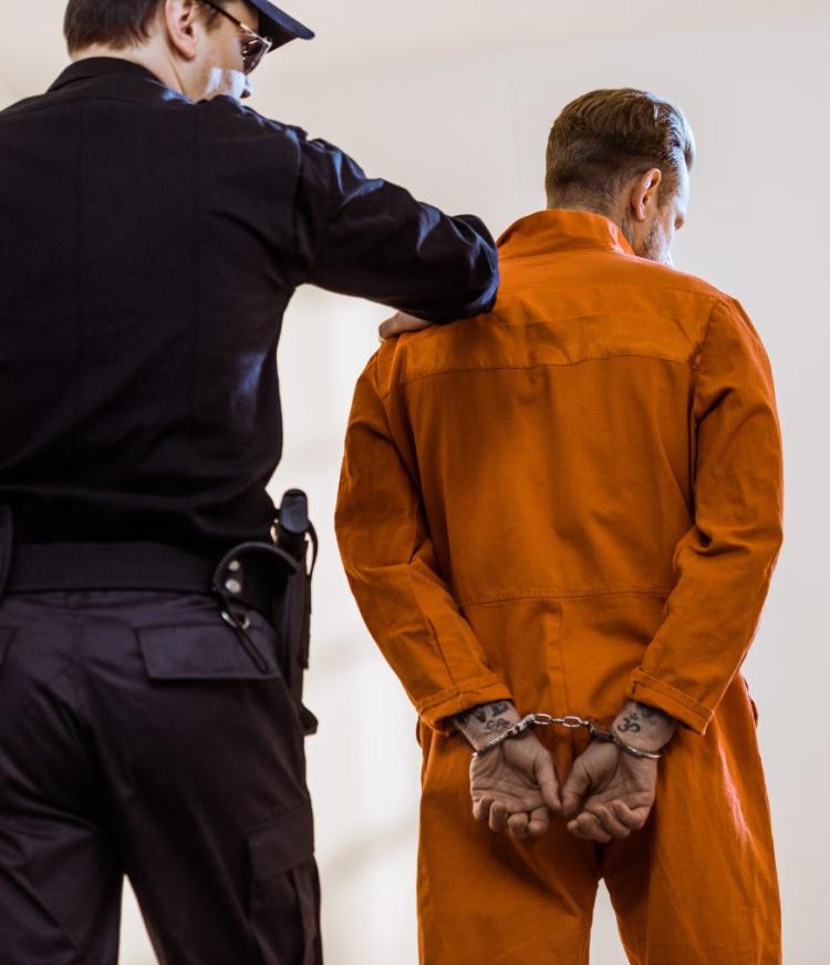 A police and a prisoner in handcuff