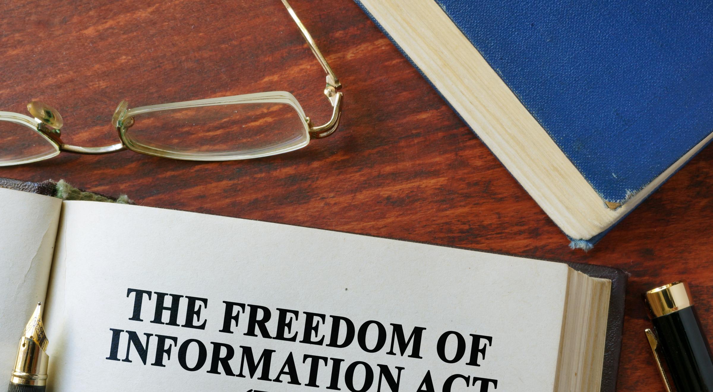 Book with title "Freedom of Information (FOIA)" and a pair of glasses